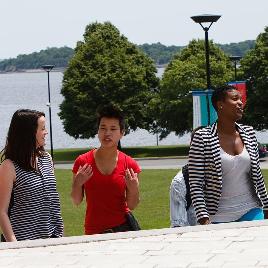 Students walk and talk with each other on stairs outside the Campus Center.