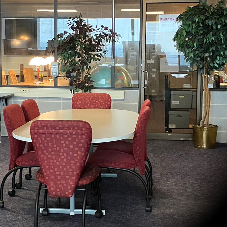 An image of a conference table with chairs around it