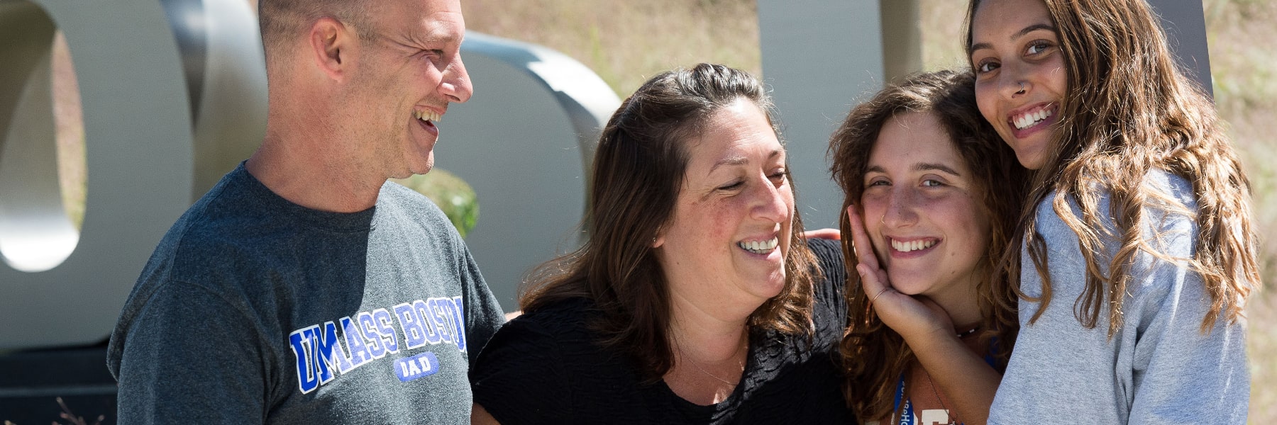 parents embrace enrolled UMass Boston Student on Move In Day