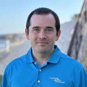 Man with short brown hair, blue shirt