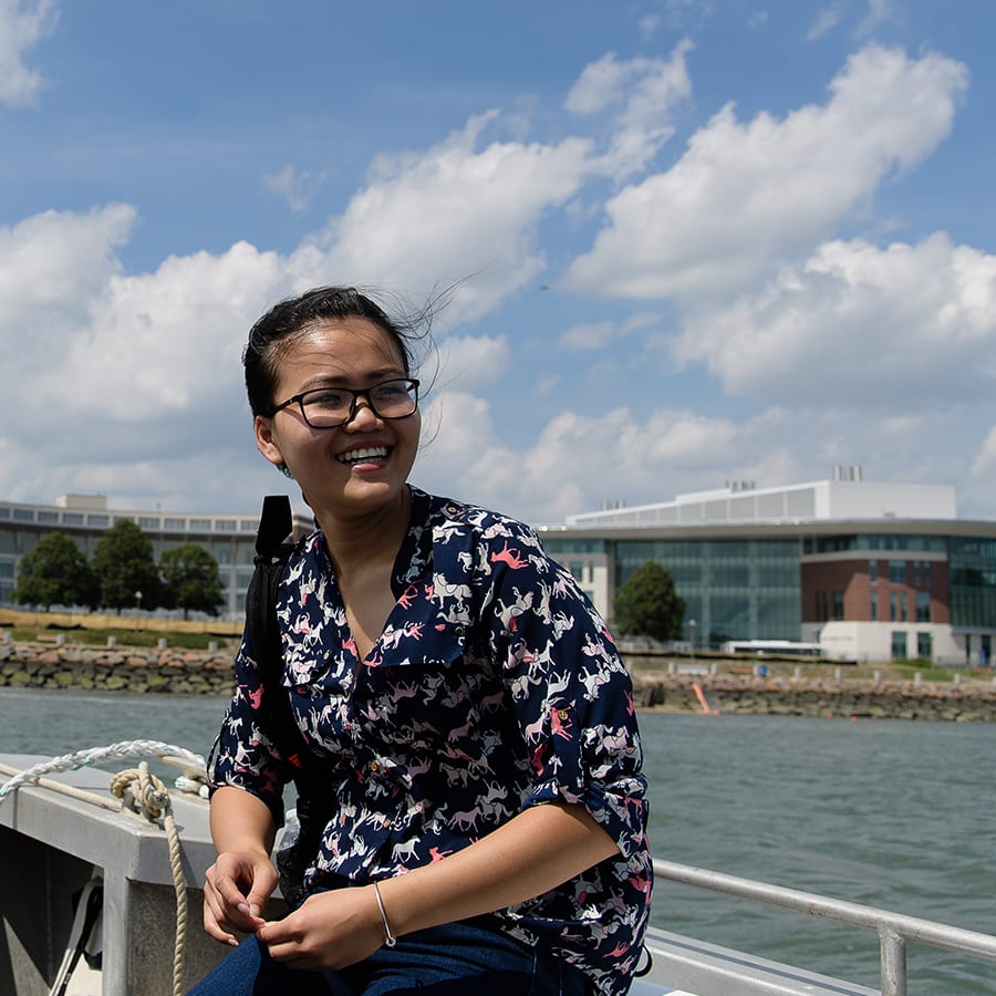 Student on a boat in front of Campus Center.