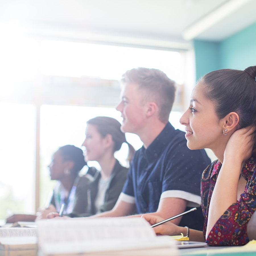 students in a row in classroom.