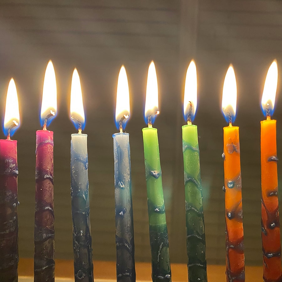 lighted colorful candles on menorah. Credit: Amy Feingold unsplash