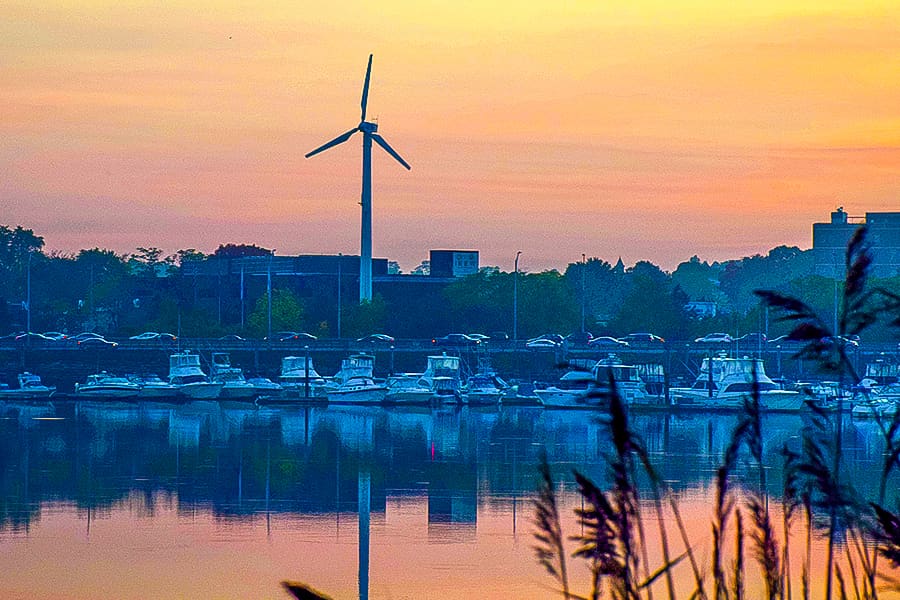 Clean Energy wind turbine Boston at sunset.